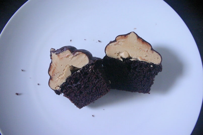 Creamy peanut butter buttercream is revealed when these chocolate hi hat cupcakes with peanut butter buttercream are split open. #peanutbutter #chocolate #cupcakes #buttercream